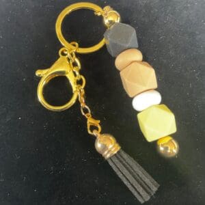A key chain with beads and a tassel.