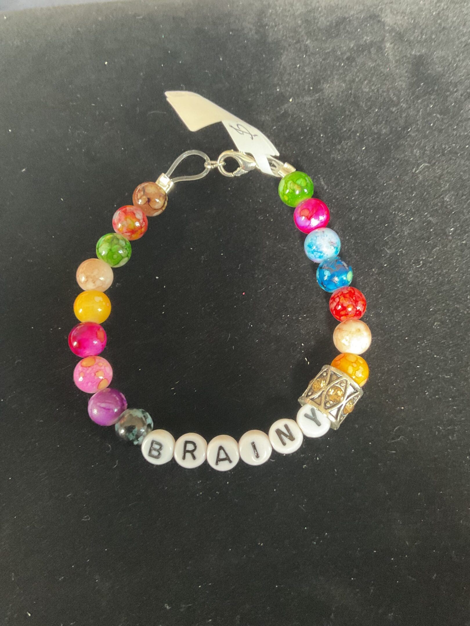 Colorful beaded bracelet spelling "brainy"