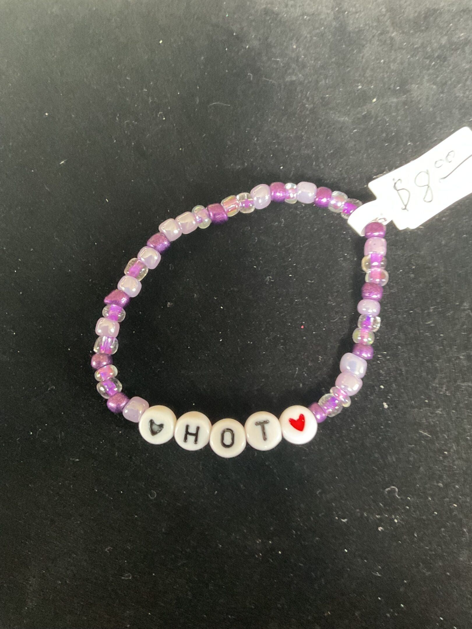 Purple beaded bracelet: "HOT" with hearts.
