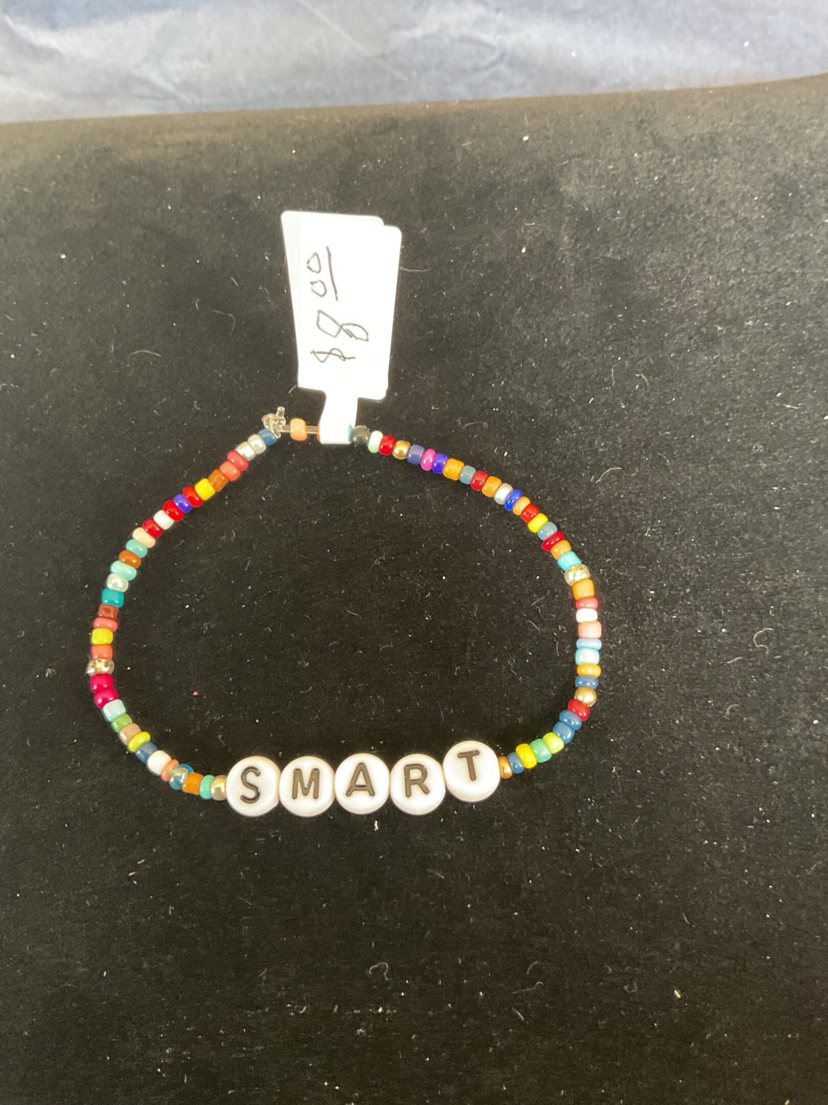 Colorful beaded bracelet spelling SMART.