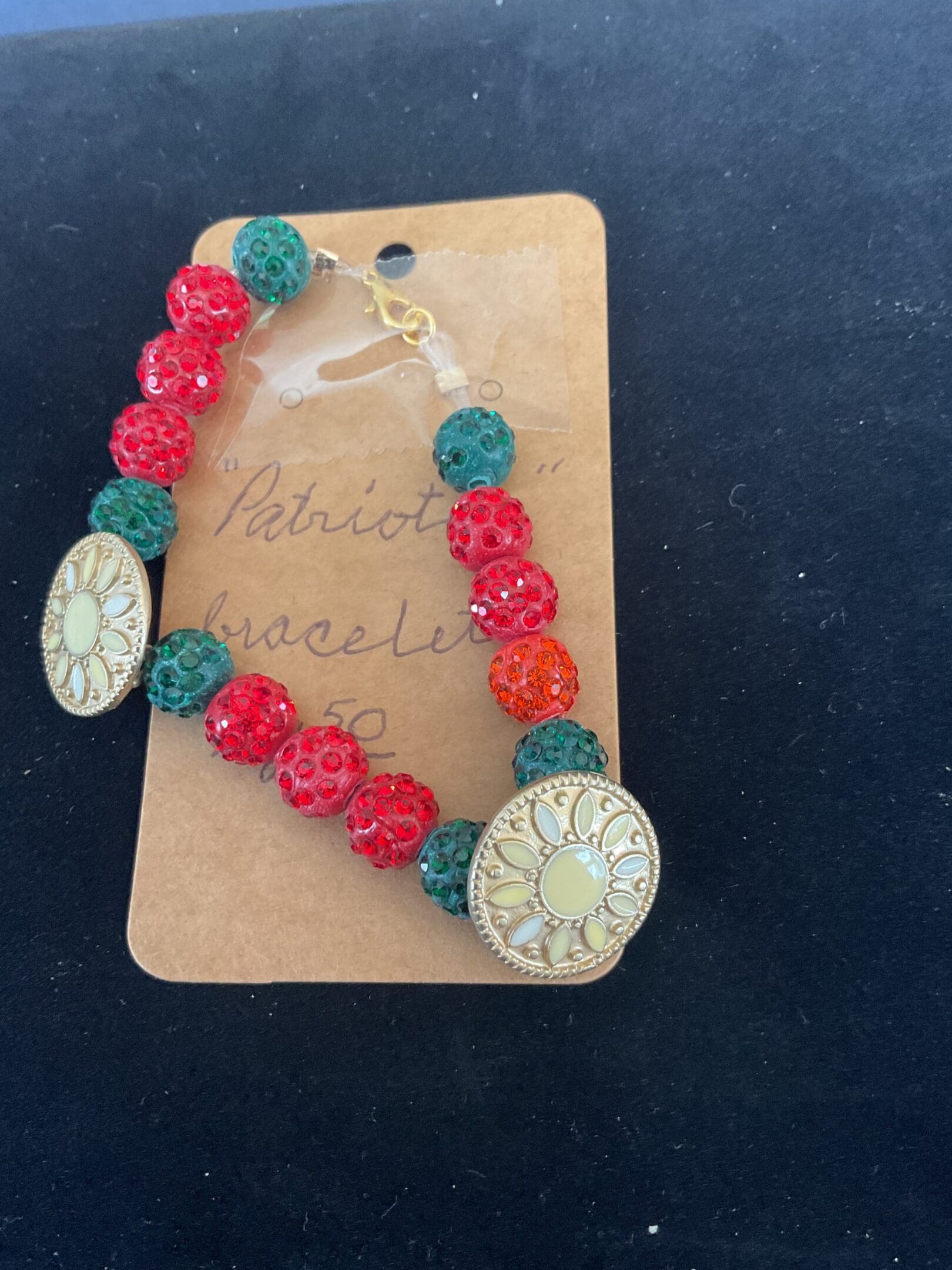 Red, green, and gold beaded bracelet.