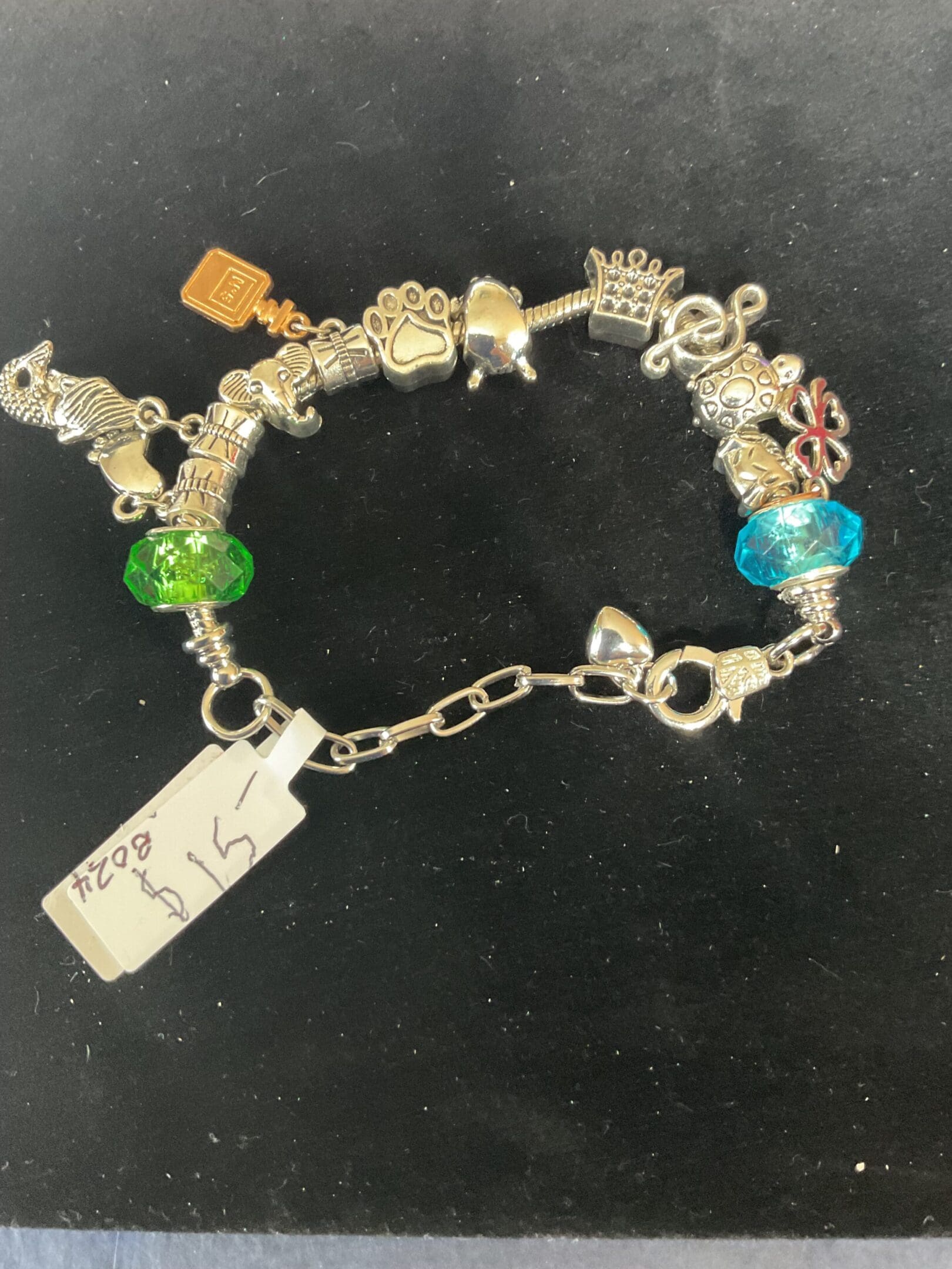 Silver charm bracelet with colorful beads.
