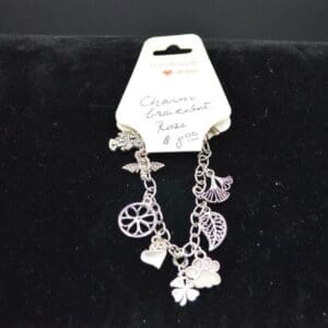 Silver charm bracelet with floral accents.