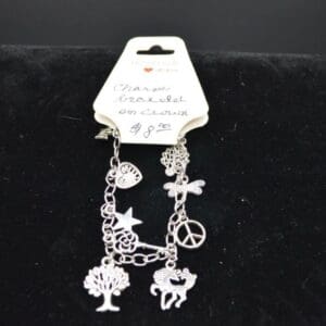 Silver charm bracelet with peace sign.