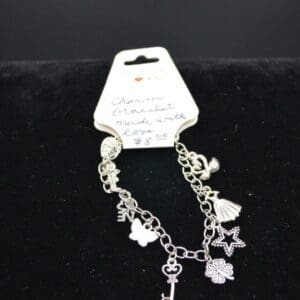 Silver charm bracelet with various charms.